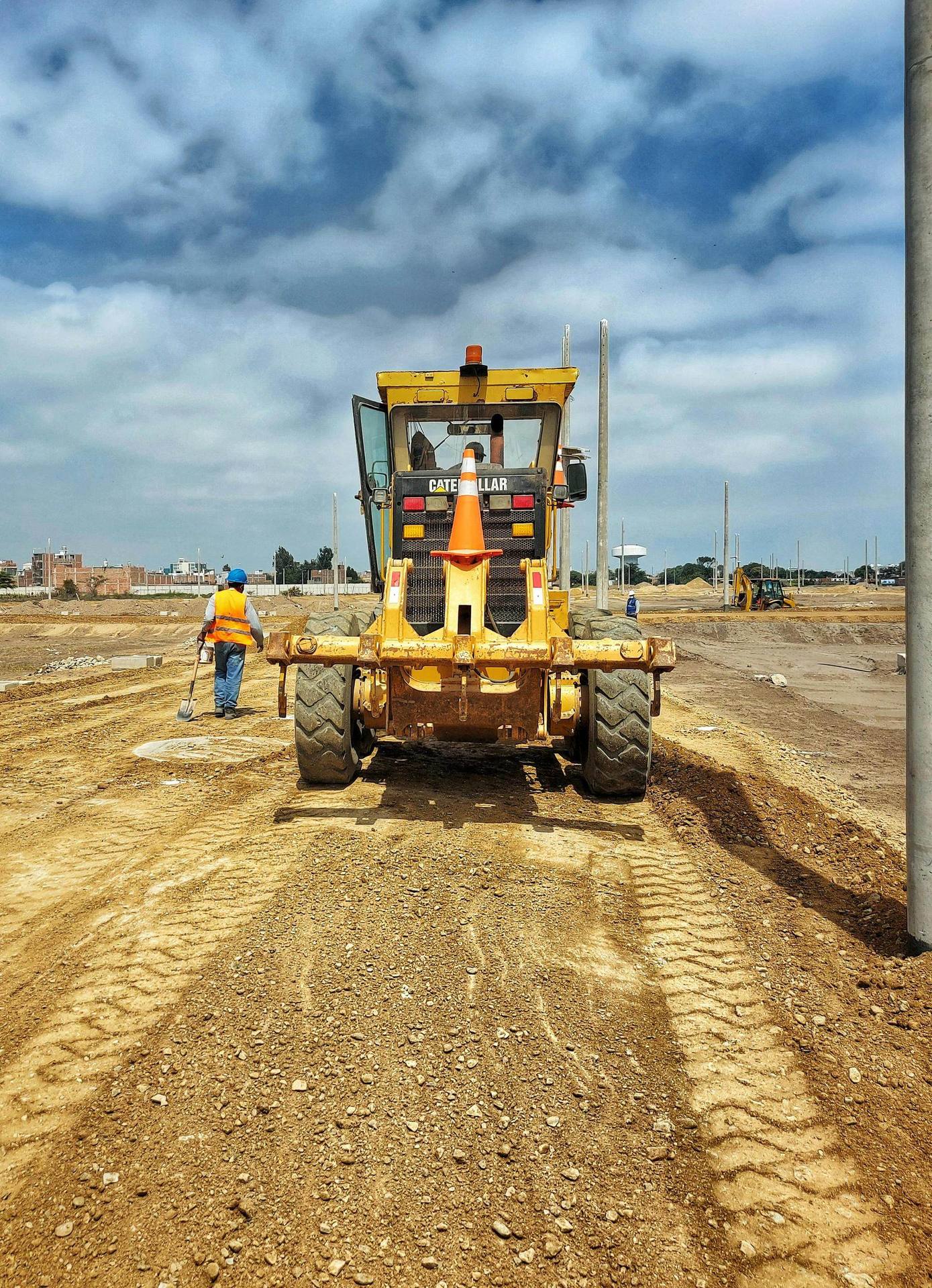 Motor grader finishing a cleared lot for construction