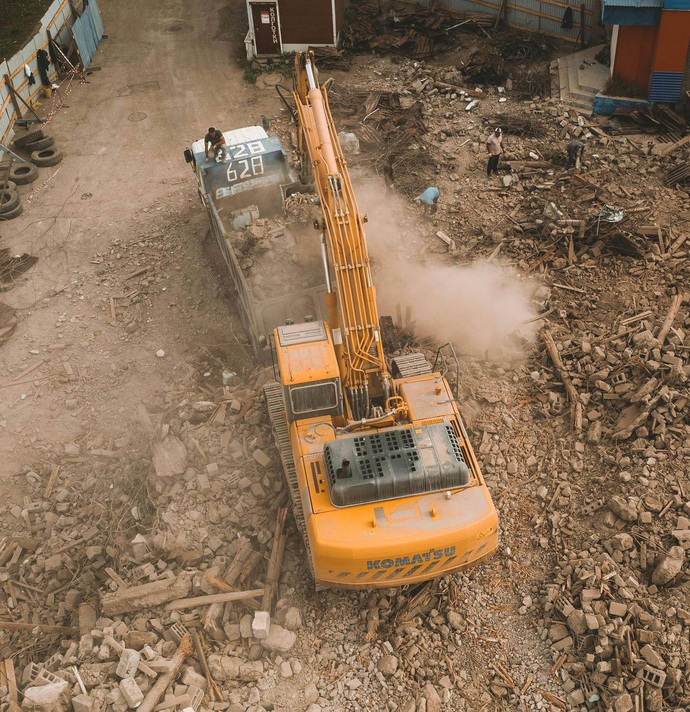 Aerial view of demolition debris being loaded into a truck