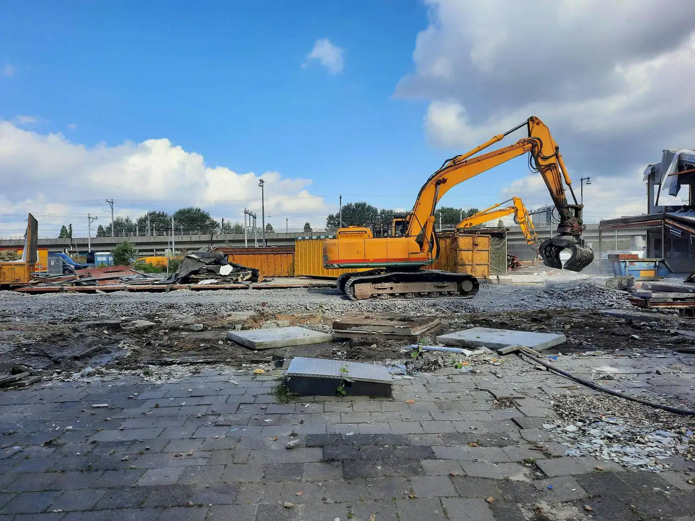 Detroit Oakland County urban demolition project with elevated rail infrastructure in background